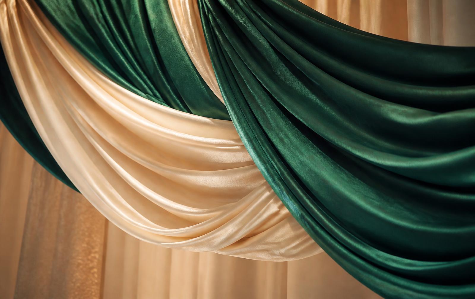 Layered emerald and champagne drapery fabric detail