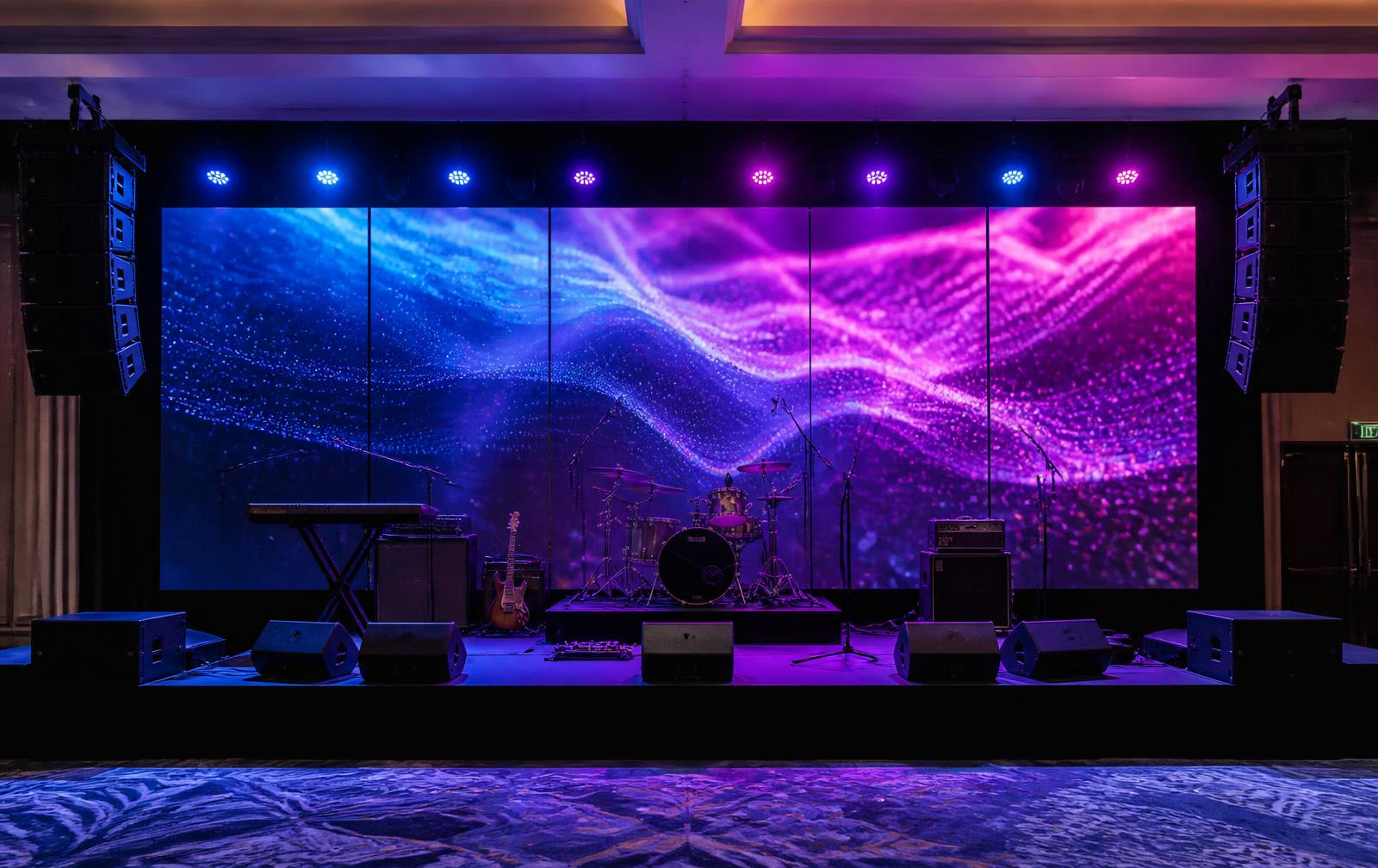 Live band stage with LED wall, drum kit, keyboard, guitar equipment and stage monitors